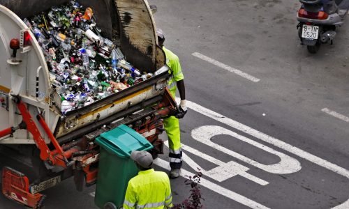 people collecting trash in garbage truck